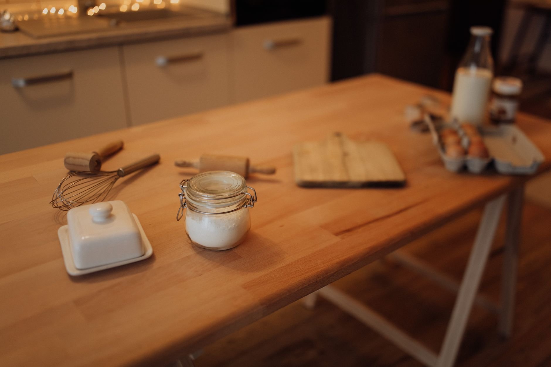 Kitchen baking tools and ingredients on a warm wooden surface