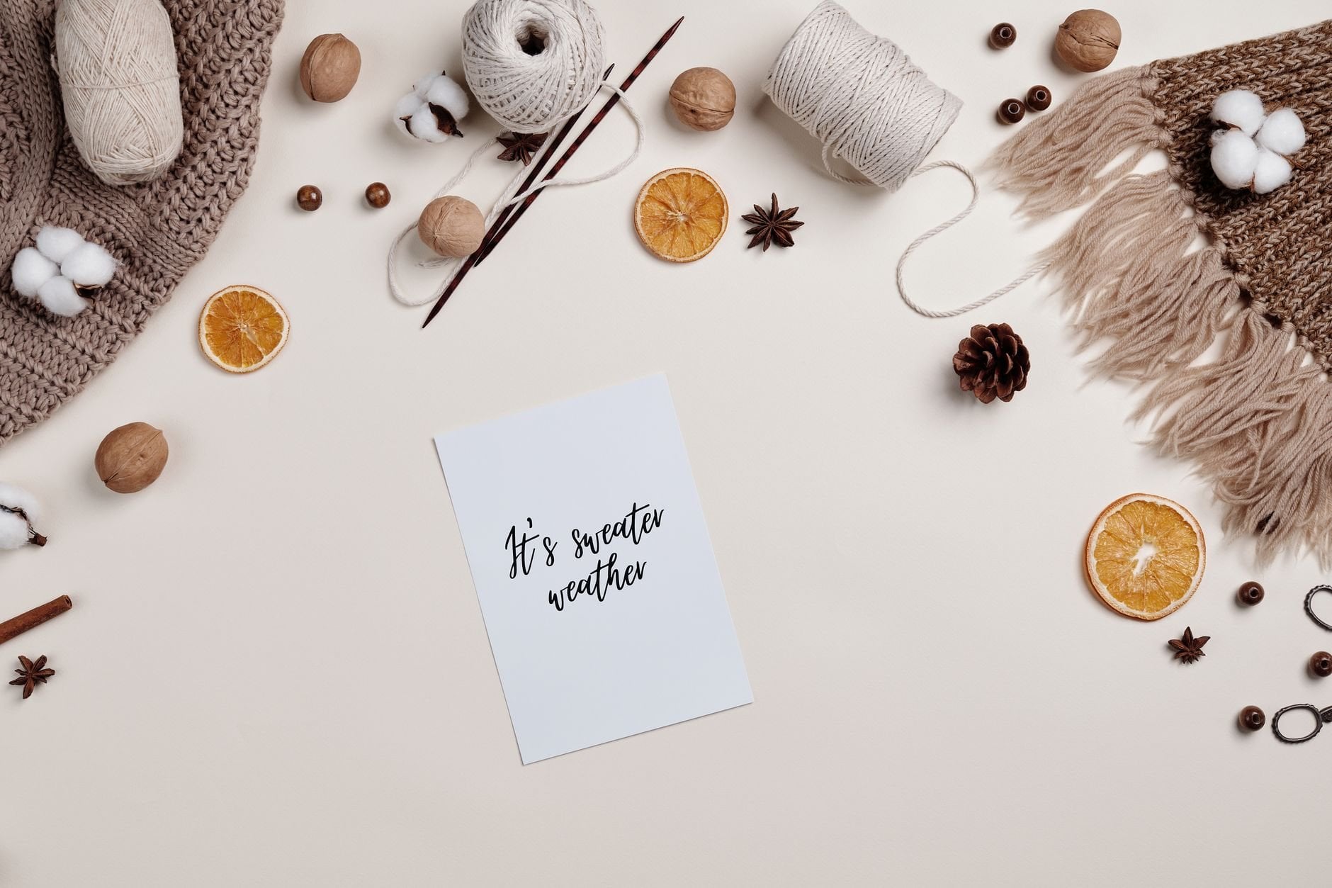 Curated lifestyle objects — knitting supplies and autumn decorations in warm tones